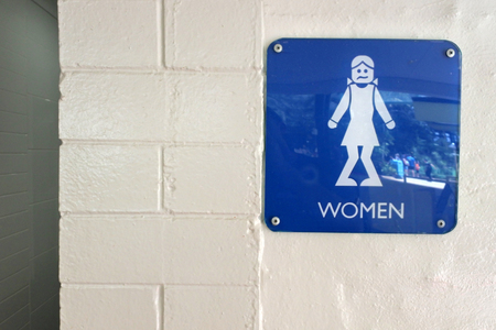 Urinary Urgency Toilet Sign for girls at the entrance to a public toiletの写真素材