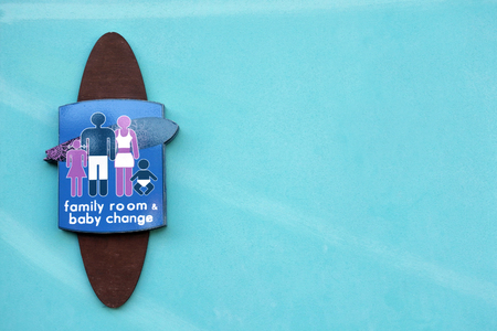 Toilet sign for family room and baby change in the shape of a surf board at the entrance to a public toiletの写真素材
