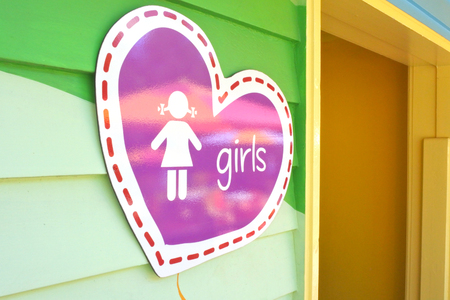 Toilet sign for girls in the shape of a heart at the entrance to a public toiletの写真素材