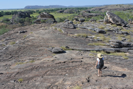 Australian adult woman tourist hiking at Ubirr rock art site in Kakadu National Park Northern Territory of Australia.のeditorial素材