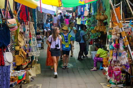Ubud, Bali, Indonesia - July 2019:Tourists shopping at Ubud Market in Bali Island Indonesia. Ubud located in the uplands of Bali, Indonesia, is known as a culture centre for traditional food and crafts.のeditorial素材