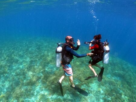 Child girl doing a scuba diving course in Gili Islands a world renown diving near Bali and Lombok Islands Indonesia.の写真素材