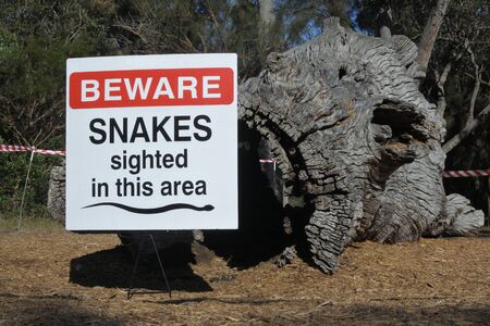 PERTH, WA - OCT 14 2019:Beware snakes sign in Perth Western Australia.Australia is home to the world's top 3 most venomous snakes but only 2-4 fatalities occur each year, compared to 11,000 in Asia.の写真素材
