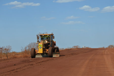 TOME PRICE,WA-0CT 11 2019:Motor Grader flatting a dirt road surface in Western Australia,one of the largest geographically-spread road system in the world,18,500Km of road spread over 2.5 million km2.のeditorial素材