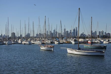 Sailboats against Melbourne financial district skyline in Victoria, Australia.の写真素材