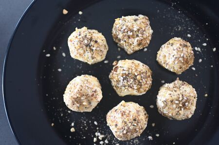 Above view of Labane yogurt cheese balls served on a black plate.