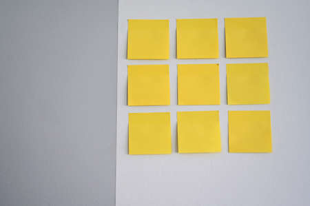 Group of empty sticky notes on a wall. Concepts and ideas.  Abstract, pattern, background and...