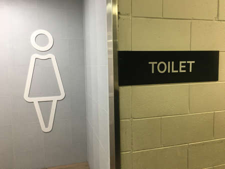 Public toilet rest room for woman sign.