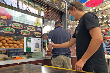 PERTH, WA - FEB 10 2021:Australian person  scan the QR code of SafeWA a  COVIDSafe app that collects information from customers and stores.のeditorial素材