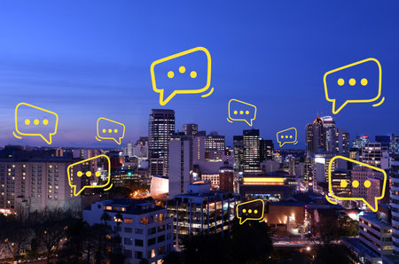 Talking bubbles over urban aerial view of a modern city downtown skyline at night. No people. Copy spaceの写真素材