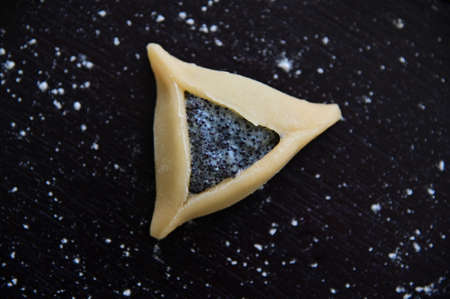 Flat lay view of one Hamantash cookie preparation for Purim Jewish holiday.