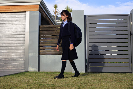 Young schoolgirl (female age 10-11) going to school from home.の写真素材