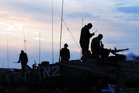 GAZA STRIP - NOV 19 2009:Silhouette of Israeli tank crew prepares for a land Incursion into Gaza Strip during Cast Lead operation.It was a three-week armed conflict in the Gaza Strip during the winter of 2008-2009.