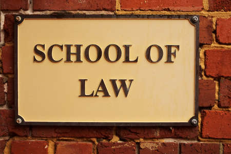 School of Law sign hanged on an old brick wall.の写真素材