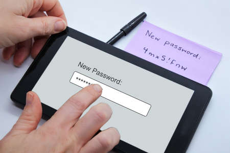 POV (point of view) of a  person changing new password on a tablet portable device. Cyber security concept.の写真素材