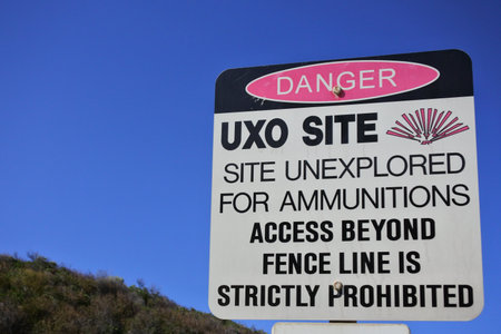 PERTH, WA - SEP 23 2021:Warning sign reads: Danger UXO (Unexploded Ordnance) site. In addition to the obvious danger of explosion, buried UXO can cause environmental contamination.のeditorial素材