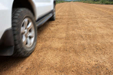 Motion blurry of a 4WD off road vehicle driving on a very corrugate dirt road in Western Australia outback.の写真素材