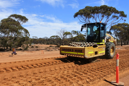 KALGOORLIE, WA - MAR 15 2022:Paving roller machine flatting a dirt road surface in Western...