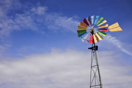 Colorful wind mill isolated on blue sky in the outback of Australia.