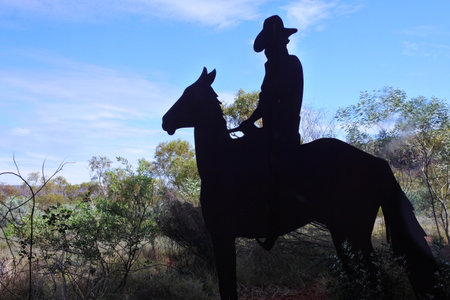TOM PRICE, JUNE 16 2022:Silhouette of Australian farmer riding a horse in the outback of Western Australia.The agricultural history of Western Australia's Golden Outback begins in the late 1800sのeditorial素材