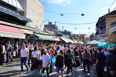 JERUSALEM - NOV 11 2022:Israeli people shopping at Mahane Yehuda Market on a busy Friday.The market...