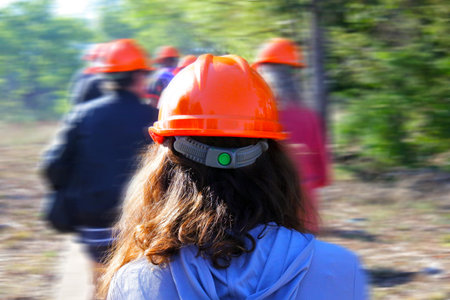 Motion blurr of group people hiking in the forest wearing hard hatsの写真素材