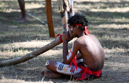 LAURA,QLD - JULY 08 2023:Indigenous Australian man play didgeridoo on ceremonial dance in Laura Quinkan Dance Festival Cape York Australia. Ceremonies combine dance, song, rituals, body decorations and costumesのeditorial素材