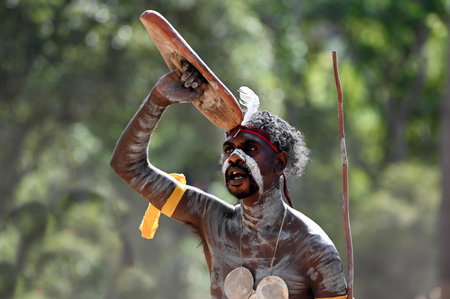 LAURA,QLD - JULY 08 2023:Indigenous Australian man holding weapons on ceremonial dance in Laura Festival Cape York Australia.Ceremonies combine dance, song, rituals, body decoration and costumes.のeditorial素材