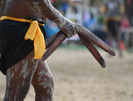 LAURA,QLD - JULY 08 2023:Indigenous Australians man holding boomerang on ceremonial dance in Laura Festival Cape York Australia. Ceremonies combine dance, song, rituals, body decorations and costume.のeditorial素材