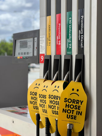 BRISBANE - DEC 12  2023:Sorry hose not in use signs on different octanes in filling station fuel pumps.Several countries and car manufacturers have plans to go all electric by the end of the decade.のeditorial素材