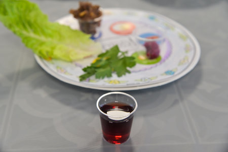 One of the Four Cups of Wine on Seder table on the night of Passover Jewish holiday.Wine is used...