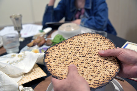 Jewish man hold handmade shmura matzo unleavened flatbread used at the Passover Seder especially for...