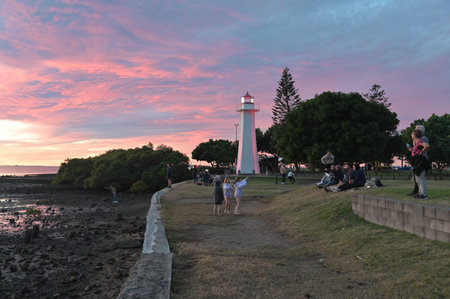 BRISBANE - JUNE 09 2024:Australian people and tourists enjoying the sunset view from Cleveland Point Light Lighthouse Brisbane Queensland, Australia.のeditorial素材
