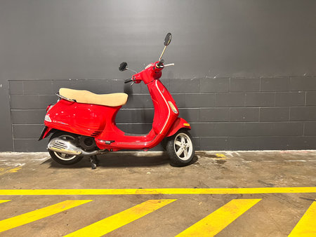 BRISBANE - MAR 01 2024:Red VESPA LX 150.Vespa celebrated its 75áµ—Ê° birthday in 2021, Vespa...