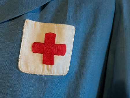 Red Cross badge on nurse uniform backgroundの写真素材