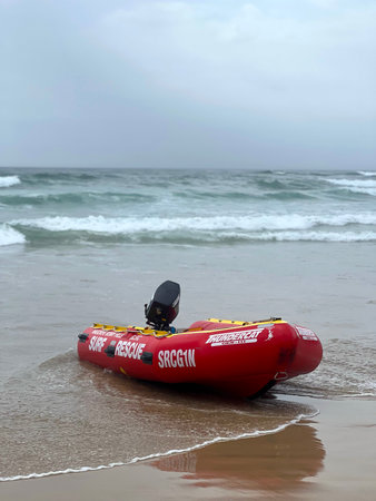PORT MACQUARIE - NOV 23 2025:Surf Life Saving Australia Rescue Boat ready on a beach on a stormy day.Inflatable Rescue Boats (IRBs) are highly effective for rapid response in surf conditionsのeditorial素材