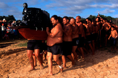 WAITANGI - FEB 6 2004:Maori warriors carry a Waka boat during Waitangi Day in Waitangi Treaty Grounds NZL.It's a New Zealand public holiday to celebrate the signing of the Treaty of Waitangi in 1840のeditorial素材