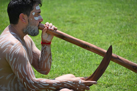 COFFS HARBOUR, NSW - JAN 26 2026:Adult Indigenous Australians man play Aboriginal music with...