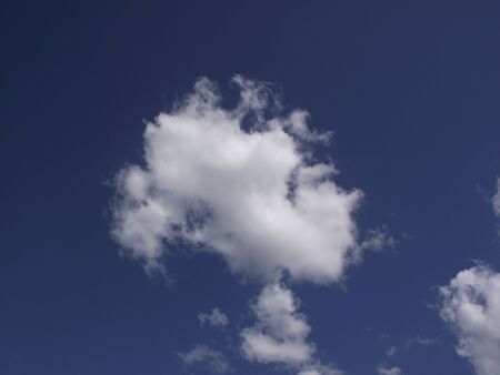 white clouds on blue sky background shotの写真素材