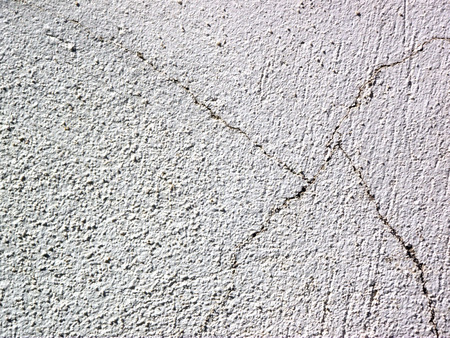 Rugged and cracked wall texture background shot on sunny dayの写真素材
