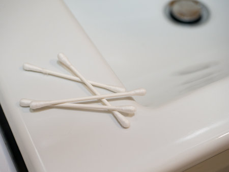 Cotton swabs in the ears on a white background.の写真素材