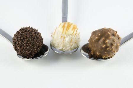 3 truffles with spoons arranged on white backgroundの写真素材