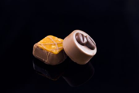 Two chocolate candies arranged on dark backgroundの写真素材
