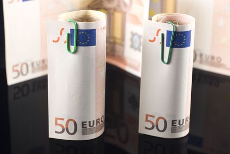 Euro banknotes arranged on black reflective backgroundの写真素材