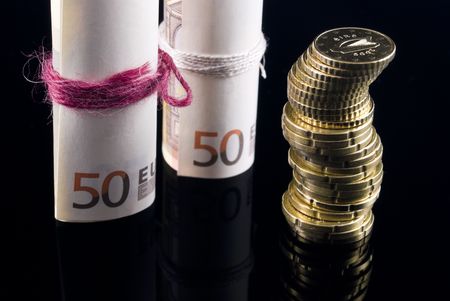 Euro notes and coins arranged on black backgroundの写真素材