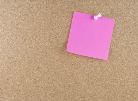 Colorful sticky blank note attached to a corkboard white thumbtackの写真素材