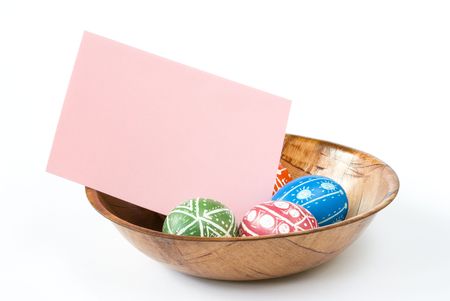 Colorful Easter eggs with blank paper copy space isolated on white backgroundの写真素材