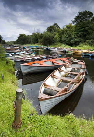 Moored boats on river in Killarney National Park, Irelandの写真素材