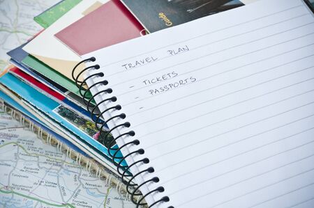 Travel plan concept with notebook, writing, map, and ballpoint pen
