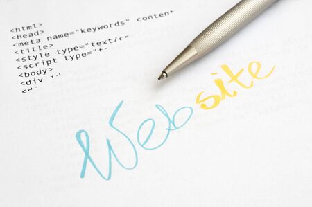Website design concept with HTML script and ballpoint penの写真素材